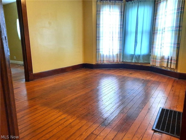 spare room with hardwood / wood-style floors