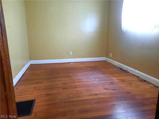 spare room with hardwood / wood-style floors