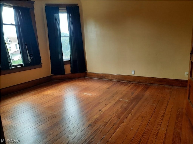 empty room with wood-type flooring