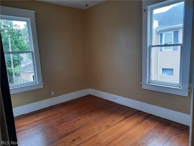 spare room featuring hardwood / wood-style flooring