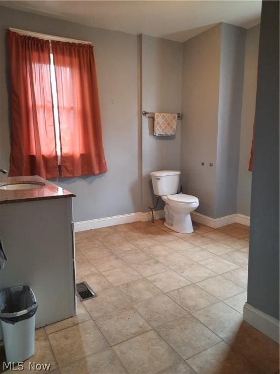 bathroom featuring toilet and vanity