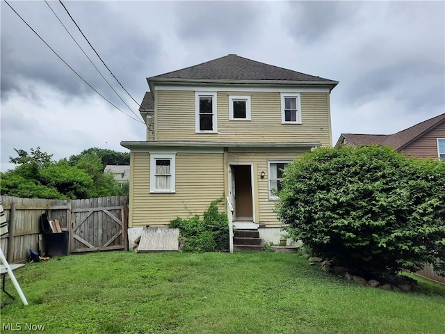 rear view of house with a yard