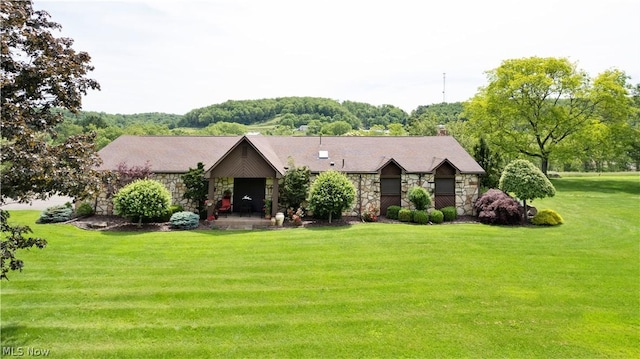 view of front facade with a front yard and a patio