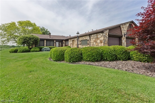 view of property exterior with a yard and a garage