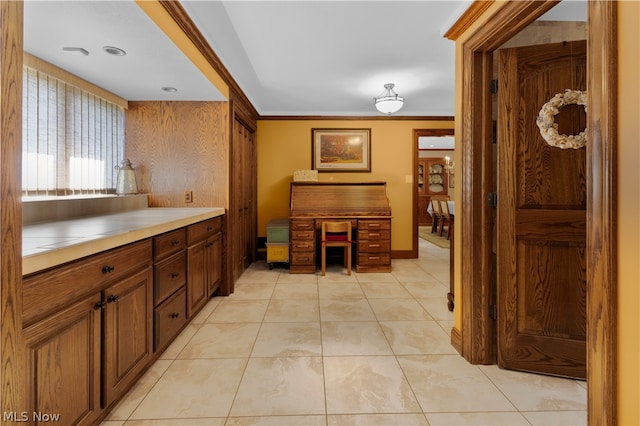 kitchen featuring light tile patterned floors and crown molding