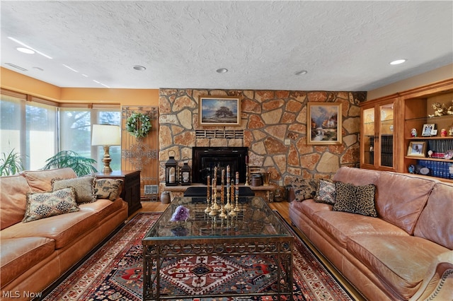 living room featuring a fireplace and a textured ceiling