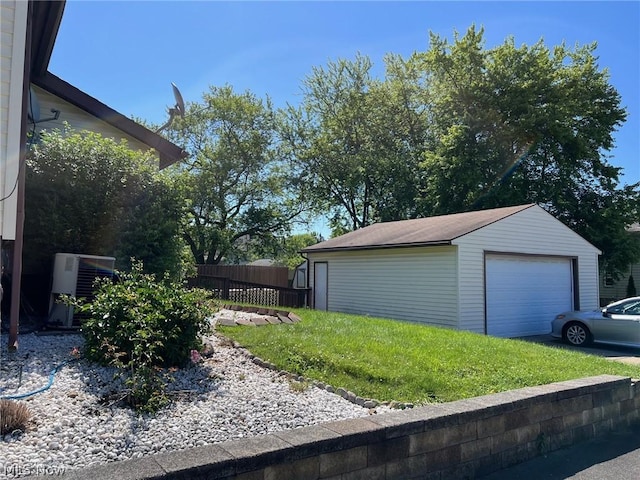 exterior space with central air condition unit, an outbuilding, a garage, and fence