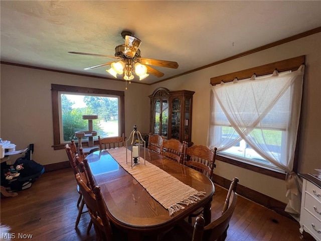 dining room with hardwood / wood-style floors, crown molding, a ceiling fan, and baseboards