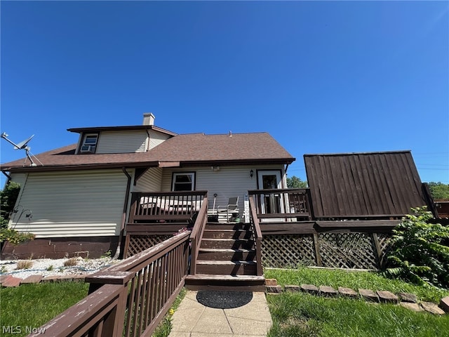 back of house with a wooden deck