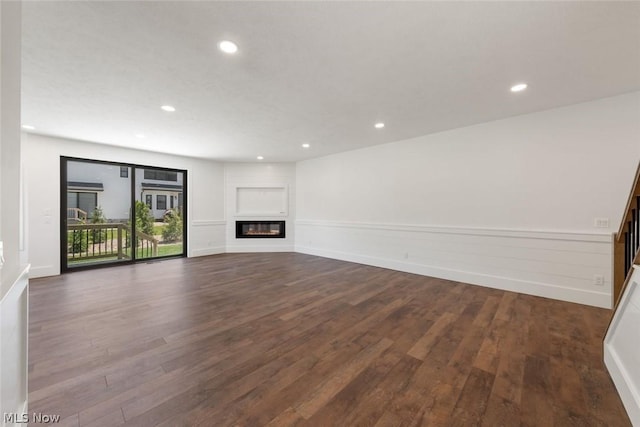 unfurnished living room with dark wood-type flooring