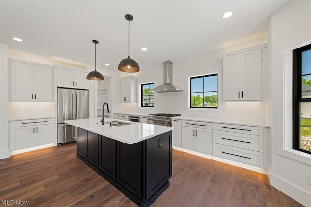 kitchen featuring white cabinets, dark hardwood / wood-style floors, high end fridge, and wall chimney exhaust hood