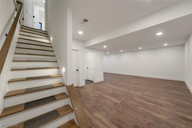 stairs with hardwood / wood-style floors