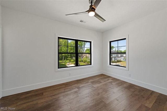 empty room featuring ceiling fan and dark wood-type flooring