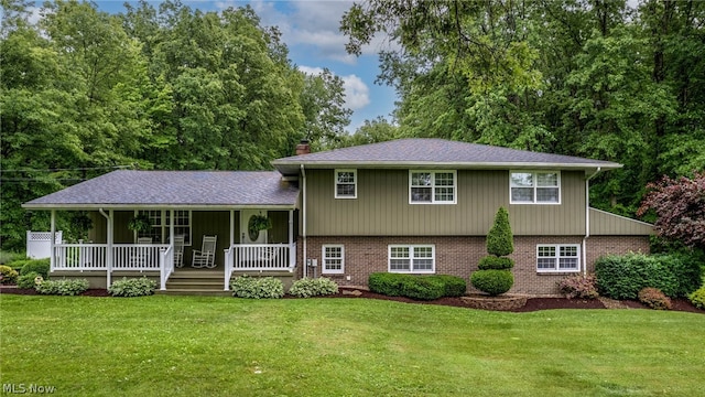 split level home with a porch and a front yard