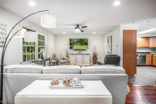 living room with dark hardwood / wood-style flooring and ceiling fan