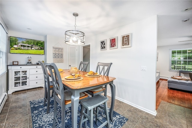 dining room with dark wood-type flooring and a baseboard radiator