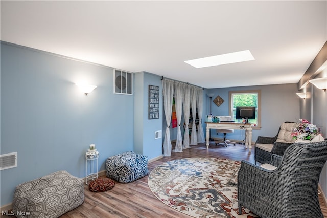 interior space with a skylight and wood-type flooring