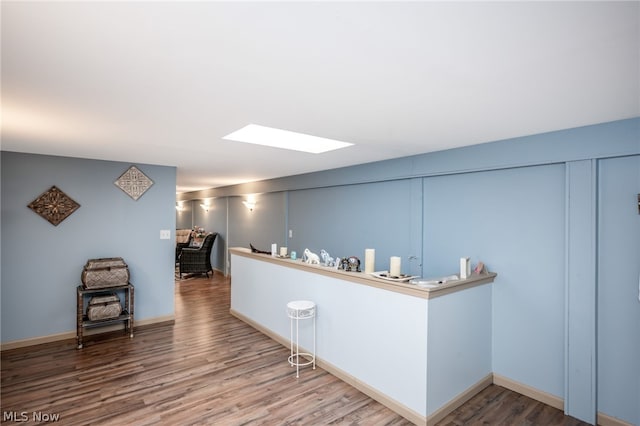 bar featuring a skylight and hardwood / wood-style floors