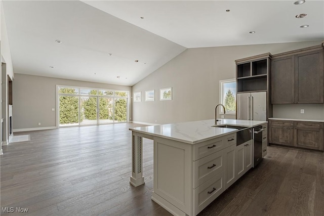 kitchen featuring appliances with stainless steel finishes, a center island with sink, a healthy amount of sunlight, and sink