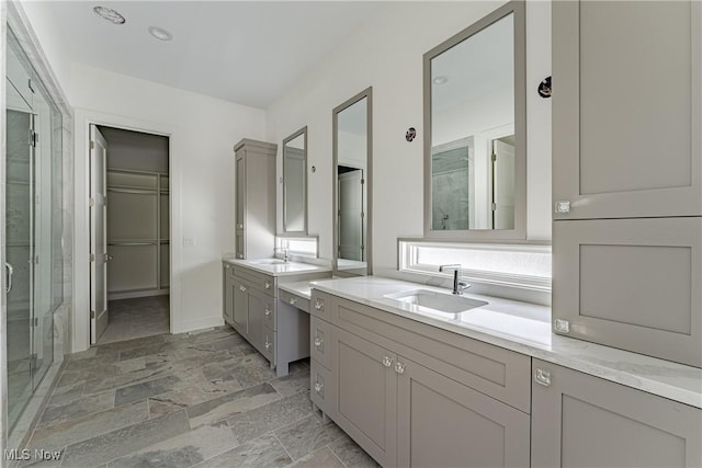 bathroom featuring vanity and a shower with door