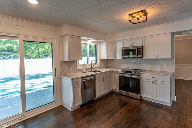 kitchen featuring sink, dark hardwood / wood-style flooring, white cabinetry, and stainless steel appliances