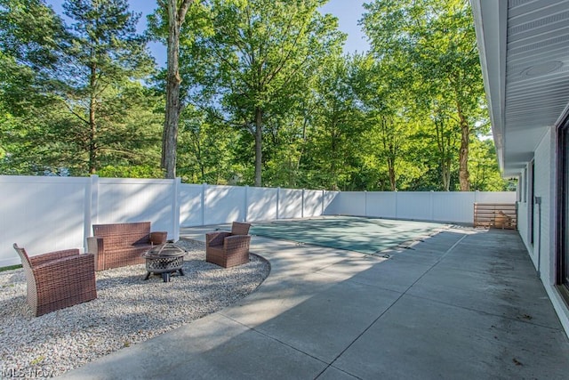 view of patio / terrace featuring an outdoor fire pit