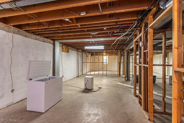 basement featuring white fridge