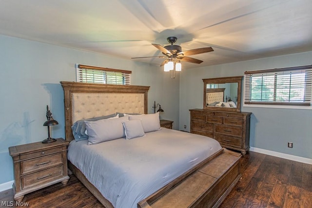 bedroom with dark hardwood / wood-style flooring and ceiling fan