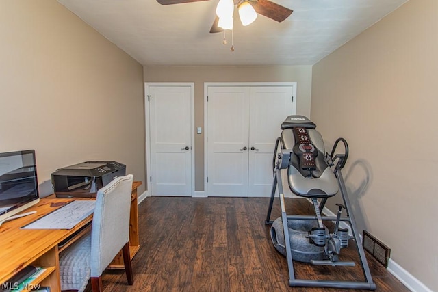 office space featuring ceiling fan and dark hardwood / wood-style flooring