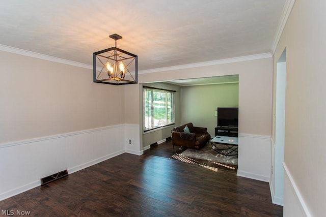 interior space with an inviting chandelier, dark wood-type flooring, and crown molding