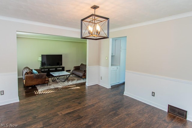 interior space featuring a chandelier, crown molding, and dark wood-type flooring