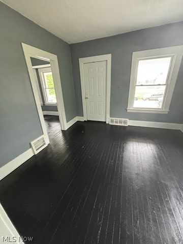 spare room featuring dark hardwood / wood-style flooring