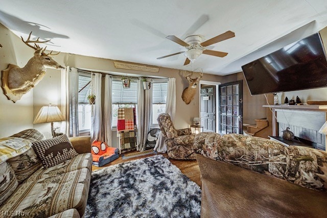 living room featuring ceiling fan and hardwood / wood-style floors