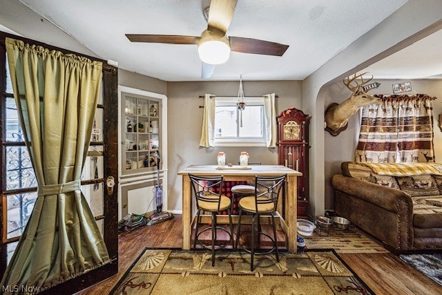 dining area featuring dark wood-type flooring and ceiling fan