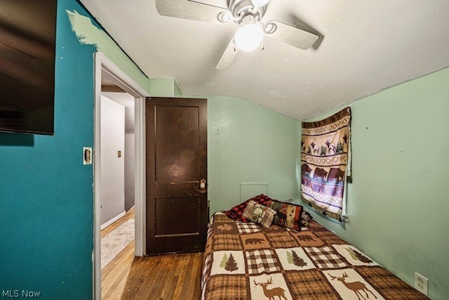 unfurnished bedroom with dark hardwood / wood-style floors, ceiling fan, and vaulted ceiling