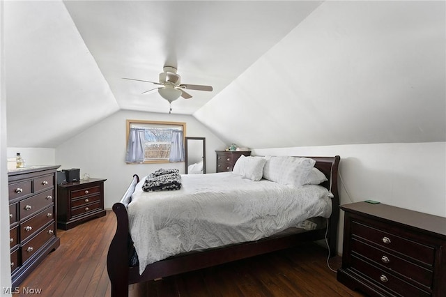 bedroom with ceiling fan, vaulted ceiling, and dark wood-type flooring