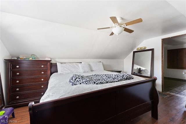 bedroom featuring ceiling fan, dark hardwood / wood-style flooring, and lofted ceiling