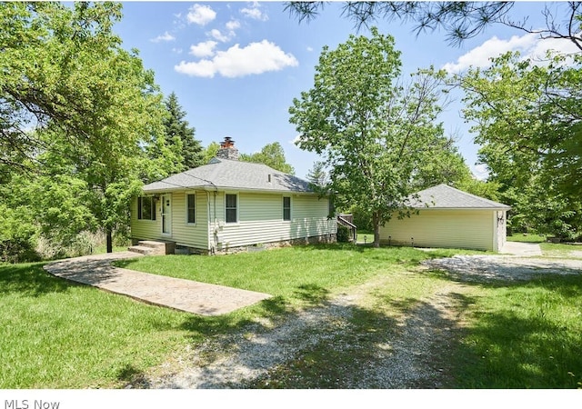 rear view of property featuring a yard