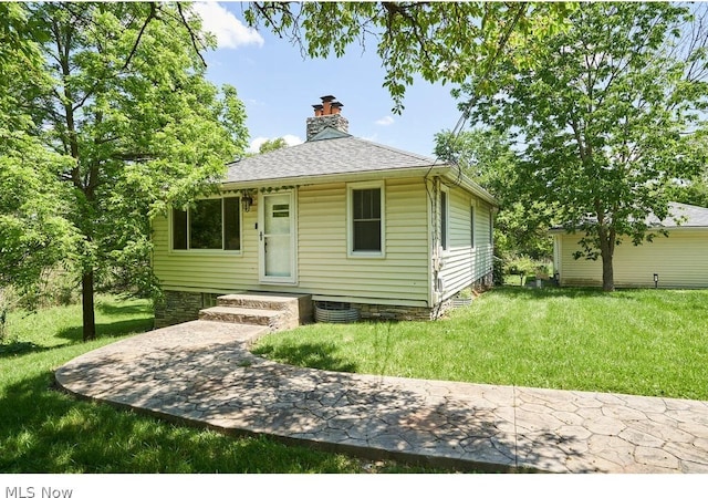 bungalow-style home with a front yard