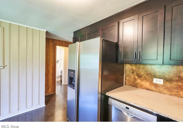 kitchen featuring backsplash, appliances with stainless steel finishes, and dark brown cabinets