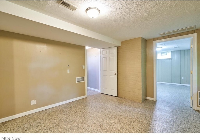 spare room with a textured ceiling