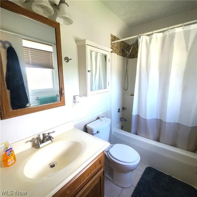 full bath featuring a textured ceiling, tile patterned flooring, toilet, shower / tub combo, and vanity