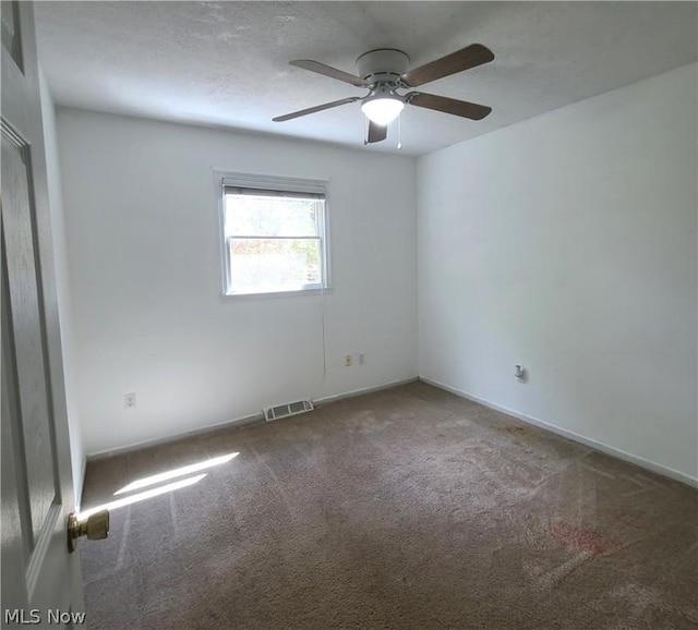 carpeted empty room with visible vents