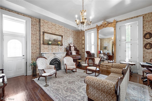 living room featuring an inviting chandelier and dark wood-type flooring