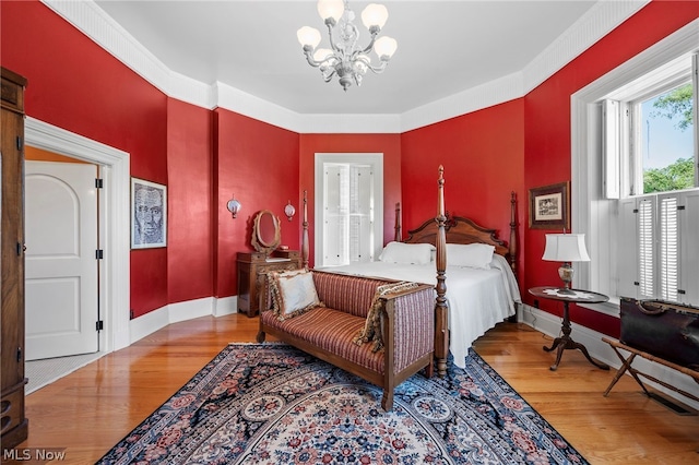 bedroom featuring an inviting chandelier and wood-type flooring