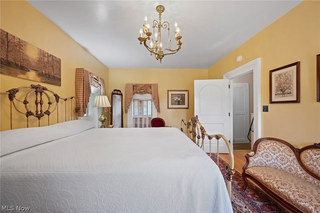 bedroom with wood-type flooring and a notable chandelier