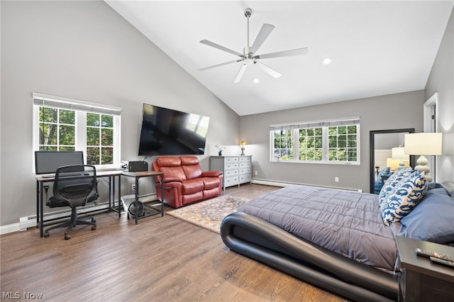 bedroom featuring ceiling fan, a baseboard radiator, multiple windows, and wood-type flooring