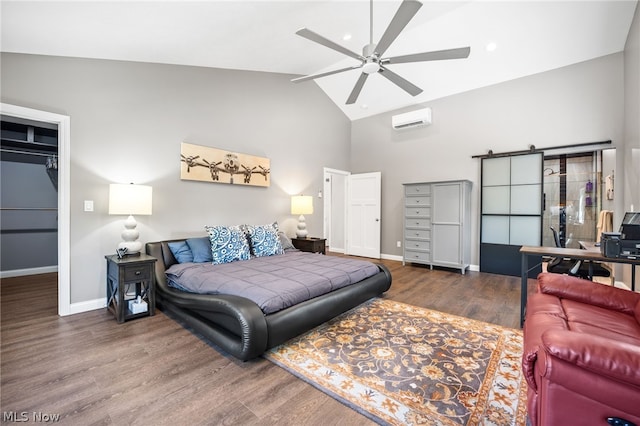 bedroom with ceiling fan, a barn door, a wall mounted AC, vaulted ceiling, and dark wood-type flooring