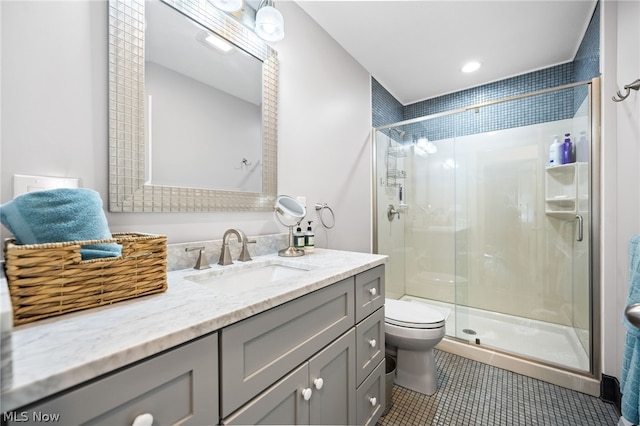 bathroom featuring toilet, tile patterned flooring, walk in shower, and vanity