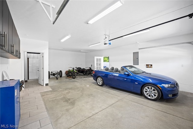 garage featuring electric panel and a garage door opener